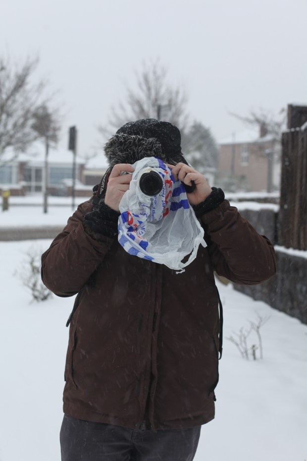 The snow can't get me! My friend Sam wrapped up warm with his Canon protected from the snow.