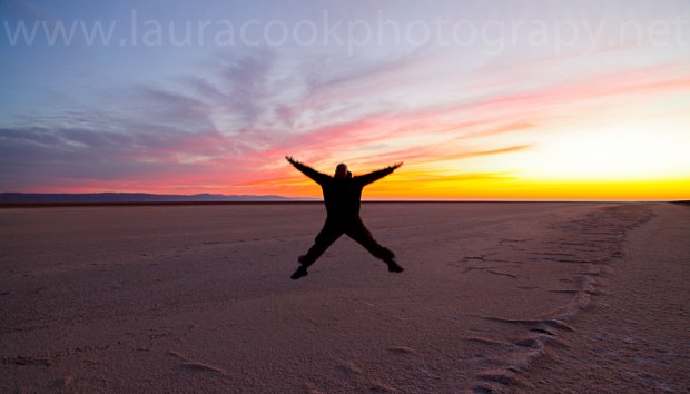 My husband leaps for the sky as the sun rises the next day over the salt flats of Chott El Jerid