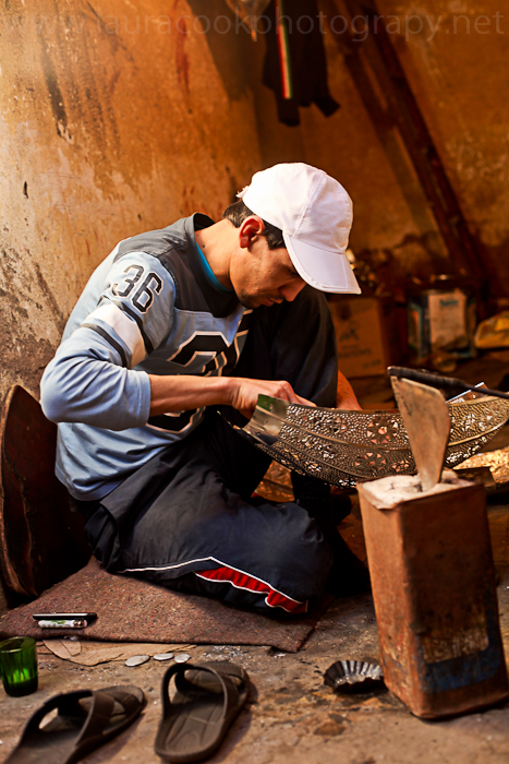 In his small workshop this craftsman works away despite the noise and hustle-bustle from the street.