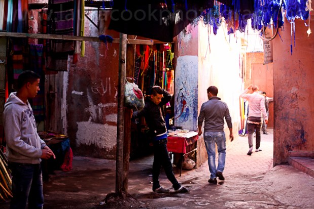 The sun is blocked out by the blue yarn hanging from the ceiling of the souk. Sellers scurry back and forth trying to tempt tourists in for a sale.