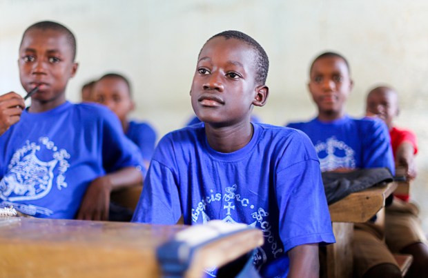 At the heart of the work of the Craig Bellamy Foundation is education. Here a Huracan FC League player studies hard in school. (Makeni,, Sierra Leone)