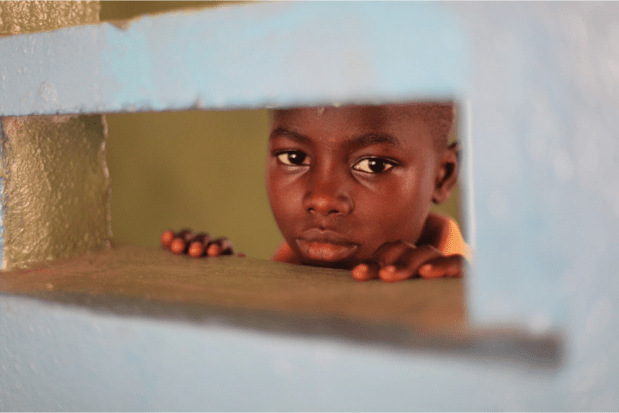 Mohamed stares into one of the classrooms at The National School for the Deaf in Freetown.