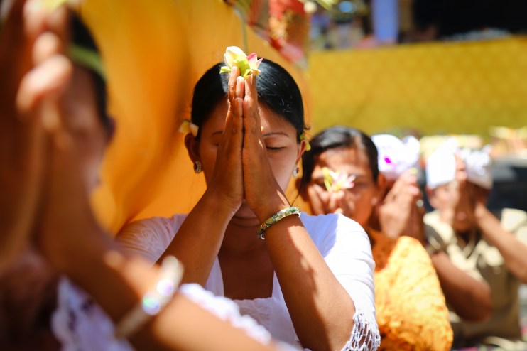 Watching, and photographing, people in prayer was intimate, personal and peaceful. On the beautiful island of Bali in Indonesia.