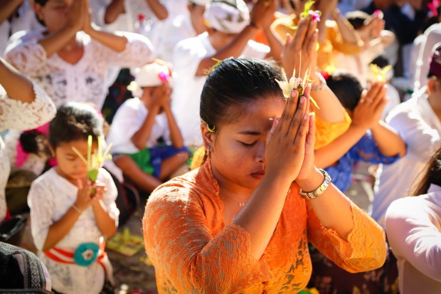 Young and old gathered to pray together. All crowded in and yet all finding their own space.