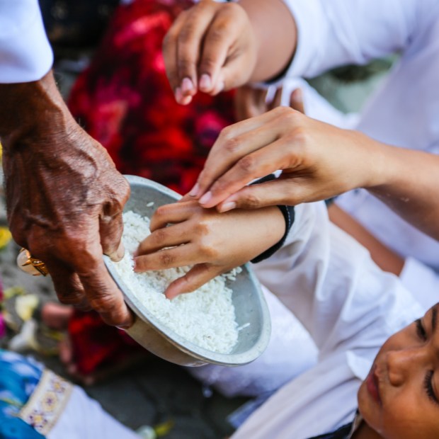 Rice and water is offered to the worshippers.