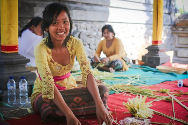 Young women weave decorations to form part of the equistite offerings for the upcoming Air Jeruk Temple ceremony.